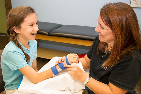A hand therapist working with a patient