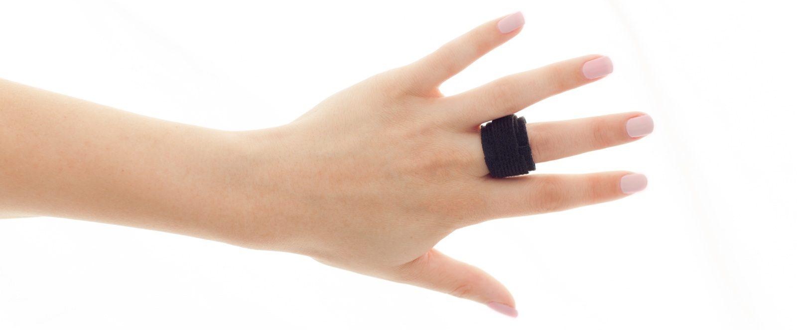 A hand wearing the HandFix trigger finger splint